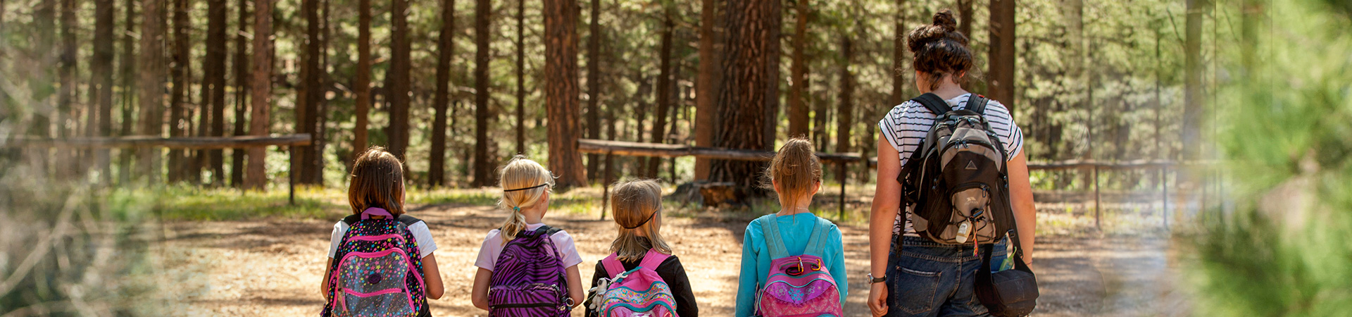  girl scouts at camp with leader 