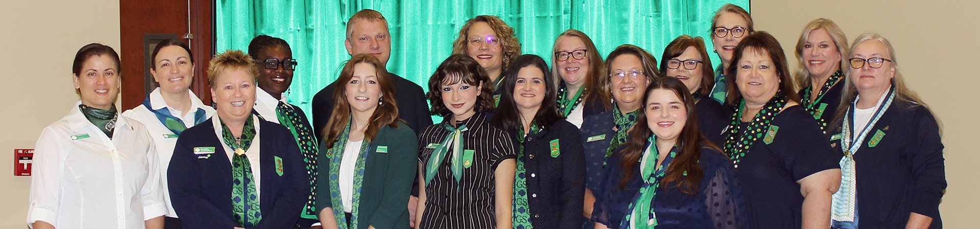  girl scout staff or volunteer wearing adult vest in woods smiling 