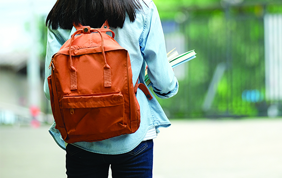 girl scout alumna with backpack