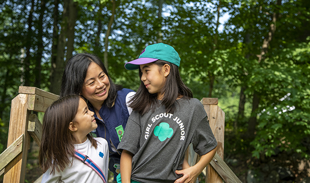 leader with two girls outdoors