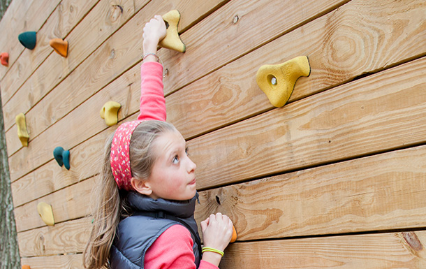 girl on rock wall climbing